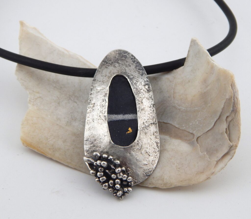 7. “Beach Stone” pendant, 2025 Materials: Sterling silver, copper, enamel, neoprene cord Size: 6.5cm long Price: $275