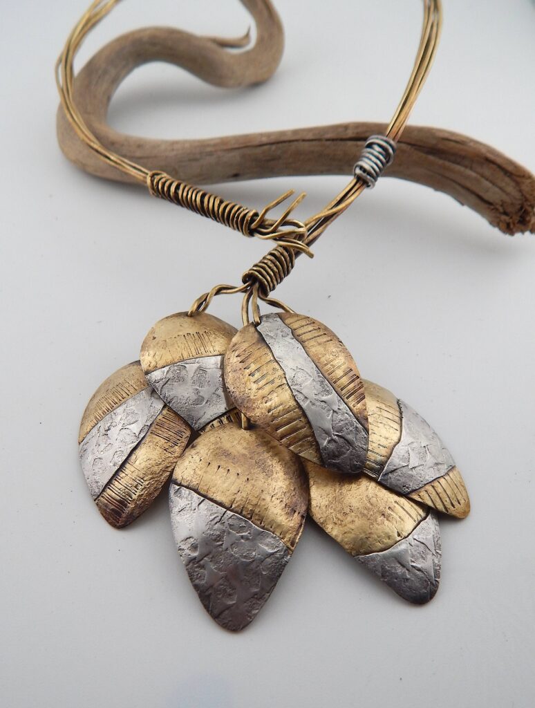 1. “Inuit Hunting Bola” neckpiece, 2025 Materials: Red brass, sterling silver Size: Cluster - 9cm x 8.5cm Price: $275