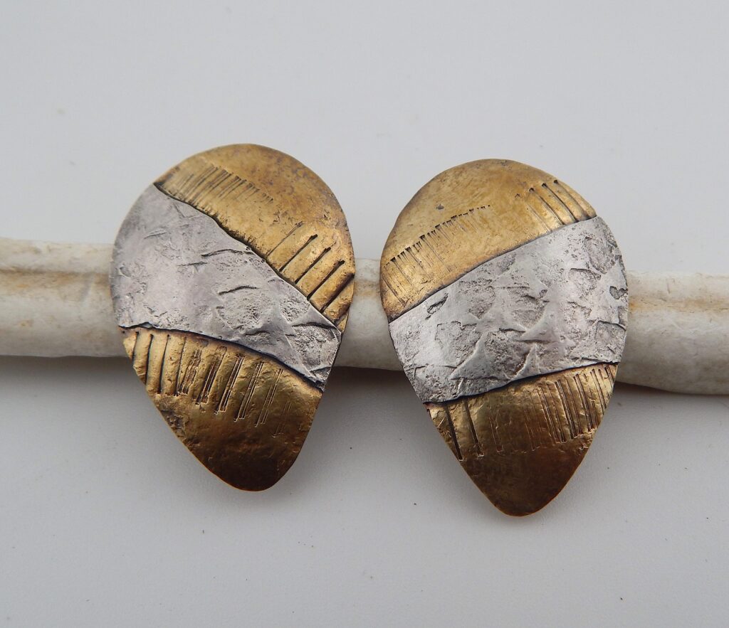 2. “Inuit Hunting Bola” posts, 2025 Materials: Red brass, sterling silver Size: 4.5cm x 3 cm Price: $85